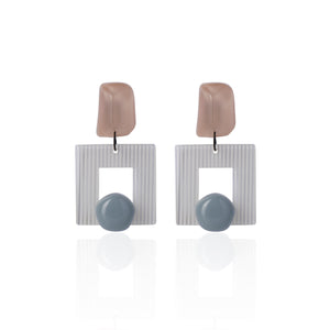 brown handcrafted earrings on white background