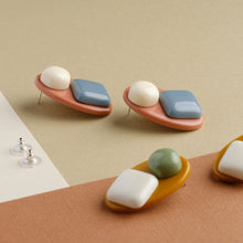 Load image into Gallery viewer, side view blue white and green borrow handmade niniwear earrings on light brown and white background
